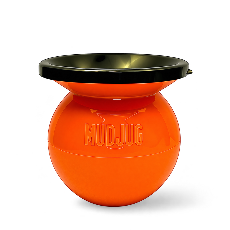 An orange spherical mud catcher with a black rim, featuring the embossed brand name 'MUDJUG' on the front, set against a plain white background.