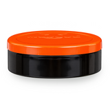 A round cosmetic jar with a glossy black body and a vibrant orange screw-on lid, shown on a clean white background.