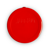 A round red plastic lid with embossed text, photographed from directly above on a white background.