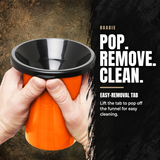An orange and black funnel-shaped container held by two hands against a textured brown and black background, with text reading 'ROADIE POP. REMOVE.