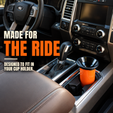 Orange Mud Jug Roadie with black funnel in a truck’s center-console cup holder. Made for the ride—designed to fit your cup holder.