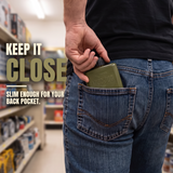 Man reaching for an olive-green Mud Jug Stealth in his back pocket in a hardware store. Keep it close—slim enough for your pocket.
